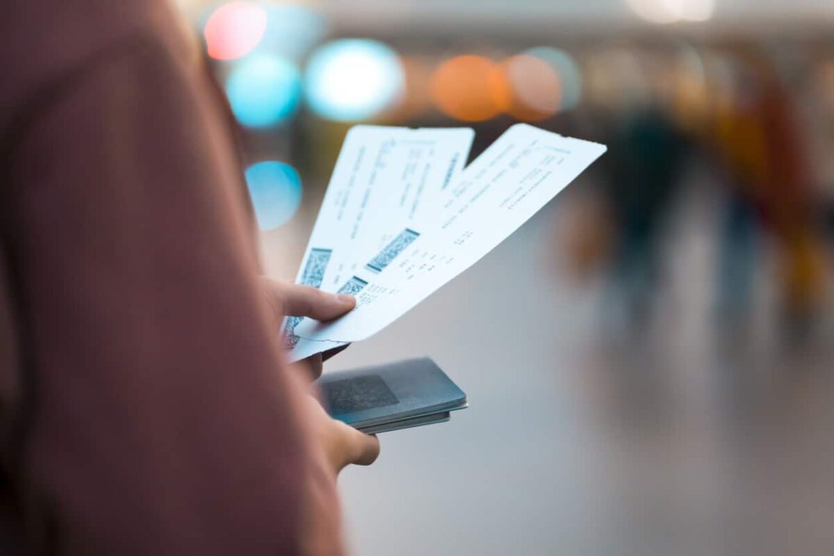 Girl holds tickets, boarding passes for a flight.